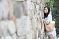 Chinese Portrait of young beautiful woman against to wall in park Royalty Free Stock Photo