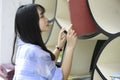 Chinese Portrait of young beautiful woman looking for Book In Bookstore