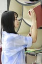 Chinese Portrait of young beautiful woman looking for Book In Bookstore