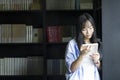 Chinese Portrait of young beautiful woman reads Book In Bookstore