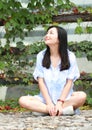 Chinese Portrait of young beautiful woman sit to wall in park Royalty Free Stock Photo