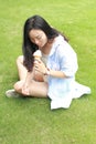 Chinese Portrait of young happy woman eating ice-cream Royalty Free Stock Photo