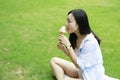 Chinese Portrait of young happy woman eating ice-cream