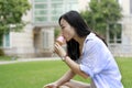 Chinese Portrait of young happy woman eating ice-cream