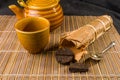 Chinese pressed PU-erh tea in bamboo leaf packaging and tea accessories, close-up, macro