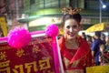 Chinese pretty fairy lady hold a signboard on parade on street at the Chinese New Year celebration.