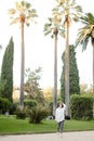 Chinese pretty girl walking in tropical park. Royalty Free Stock Photo