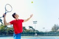 Chinese tennis player ready to hit the ball while serving Royalty Free Stock Photo