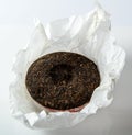 Chinese puer tea cake in unwrapped packing on Royalty Free Stock Photo