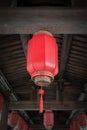 Chinese red lantern hanging from wooden crossbeam for Chinese new year