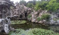 Chinese garden with waterlily pond and grey rock formations