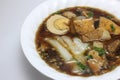 Chinese roll noodle soup with crunchy pork, egg and cinnamon Royalty Free Stock Photo