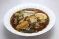 Chinese roll noodle soup with crunchy pork, egg and cinnamon Royalty Free Stock Photo