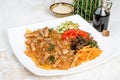 Chinese salad with funchose and vegetables in a white plate