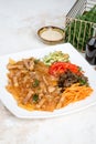 Chinese salad with funchose and vegetables in a white plate