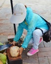 Chinese saleswoman clears coconut