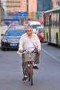 Chinese senior on his bicycle in busy traffic, Beijing, china