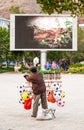 A chinese senior male street vendor selling a variety of toys in the public garden of Nansa, Yunnan, South China