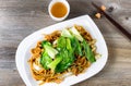 Chinese spicy noodle and vegetable dish with green tea