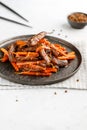 Chinese spicy Szechuan beef meal on a black plate