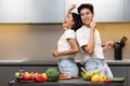 Chinese Spouses Dancing In Kitchen Having Fun Cooking Together Royalty Free Stock Photo