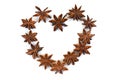 Chinese Star Anise, Star Anise, Star Aniseed, Badiane, Badian, Badian Khatai, Bunga Lawang, Thakolam, arranged in a heart shape. Royalty Free Stock Photo