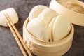 Chinese steamed buns Gua bao in a bamboo steamer close-up. horizontal Royalty Free Stock Photo