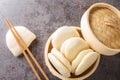 Chinese steamed buns Gua bao in a bamboo steamer close-up. horizontal top view Royalty Free Stock Photo