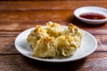 Chinese Steamed Dumpling, Shumai on white dish served with soy sauce on wooden table. Delicious Dimsum pork Royalty Free Stock Photo