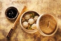 Chinese steamed dumplings in bamboo steamer with soy sauce and chopsticks Royalty Free Stock Photo