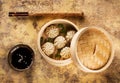 Chinese steamed dumplings in bamboo steamer with soy sauce and chopsticks Royalty Free Stock Photo