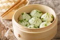 Chinese steamed pork bun baozi or bao in a bamboo steamer basket close-up. Horizontal Royalty Free Stock Photo