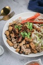 Chinese Steamed Rice Noodles with pork ,sausage,imitation Crab Stick,boil bean sprouts,mushroom and tofu in sweet soy sauce in whi