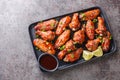 Chinese stir-fried chicken wings in sweet spicy Hoisin sauce with sesame close-up on a plate. Horizontal top view Royalty Free Stock Photo