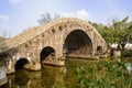 Chinese stone arch bridge over river in sunny winter afternoon Royalty Free Stock Photo