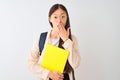 Chinese student woman wearing glasses backpack book over isolated white background cover mouth with hand shocked with shame for Royalty Free Stock Photo