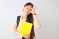 Chinese student woman wearing glasses backpack book over isolated white background with happy face smiling doing ok sign with hand Royalty Free Stock Photo