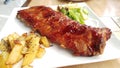 Chinese style barbecued spareribs, with chips and vegetables. very delicious food. Royalty Free Stock Photo