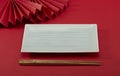 Chinese style chopsticks with red background and red folding fan, light green long plate and bamboo modeling Royalty Free Stock Photo