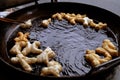 Deep fried dough food on hot pan sold for breakfast on street food in Thailand