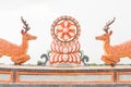 Chinese-style deer and Dharma Chakra statues