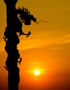 Chinese style Dragon statue silhouette with sunset