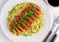 Chinese style Egg fried rice with sliced pork fillet on white wooden table. Royalty Free Stock Photo