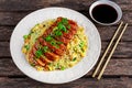 Chinese style Egg fried rice with sliced pork fillet on wooden table. Royalty Free Stock Photo