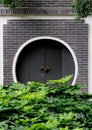 Chinese style gate with green shrubs