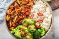 Chinese style meal with chicken stew, steamed rice and broccoli, chilli and seesame Royalty Free Stock Photo