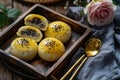 Chinese style oil pastries, small round steamed buns with yellow glaze and black seeds on top Royalty Free Stock Photo