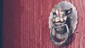 Chinese style old  red door with copper  lion head doorknob . Traditional architecture decoration to protect evil Royalty Free Stock Photo