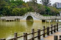 Chinese style pedestrian stone arch bridge over lake in park Royalty Free Stock Photo