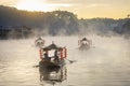 Chinese style tourist boat attraction at Ban Rak Thai village, Mae Hong Son, Thailand during winter morning sunrise with misty fog Royalty Free Stock Photo